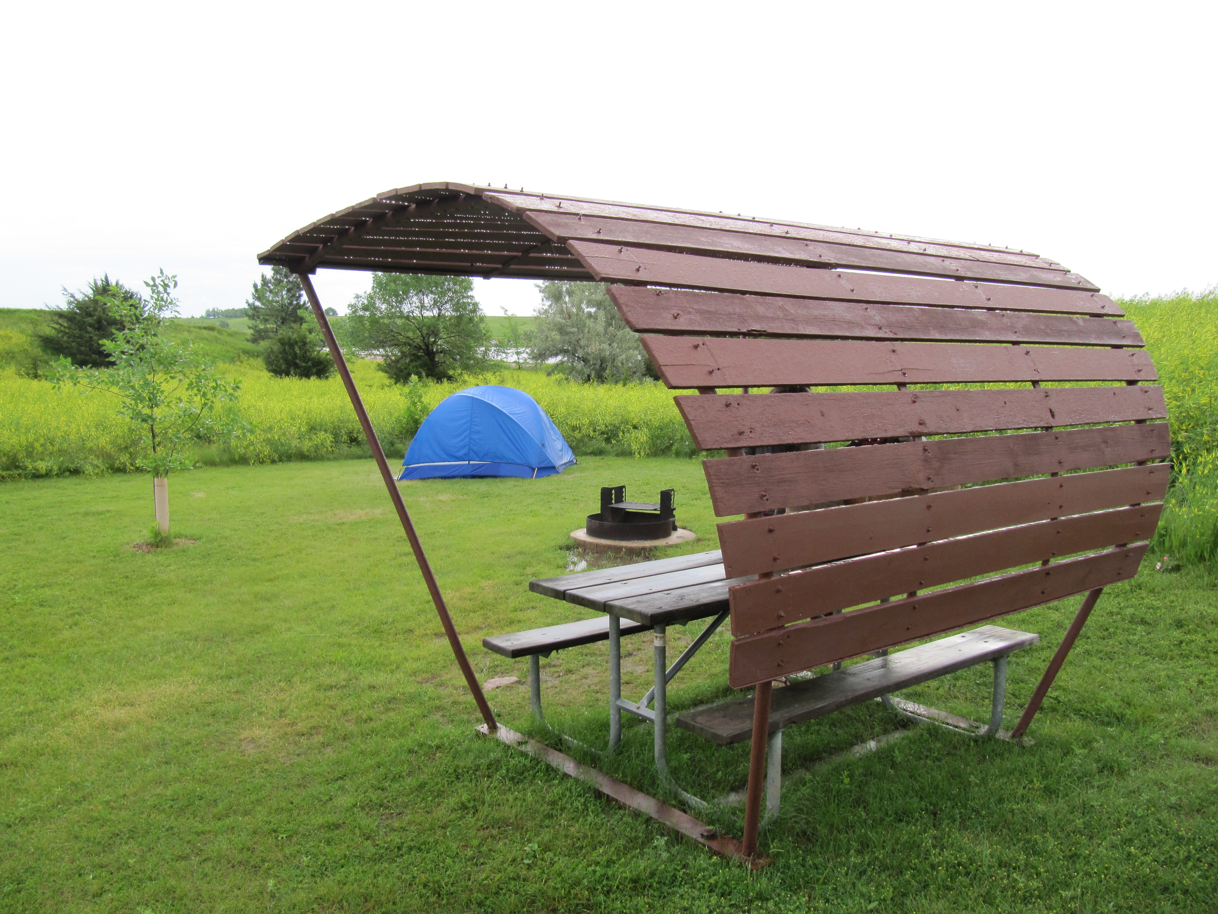 The tent sits behind a wagon-style covered table